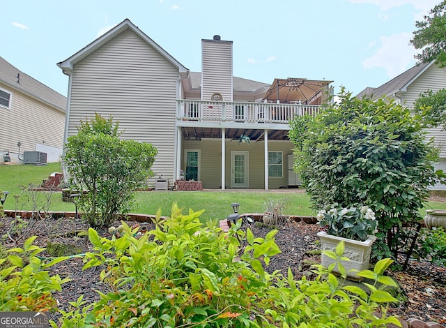 323 Newfield Way, Peachtree City, GA 30269 - back of house featuring a deck, a lawn, and a chimney