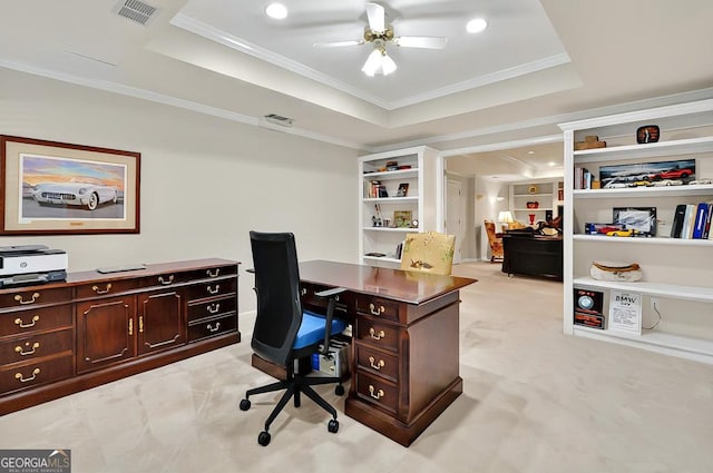 office featuring a tray ceiling, ornamental molding, a ceiling fan, light colored carpet, and recessed lighting