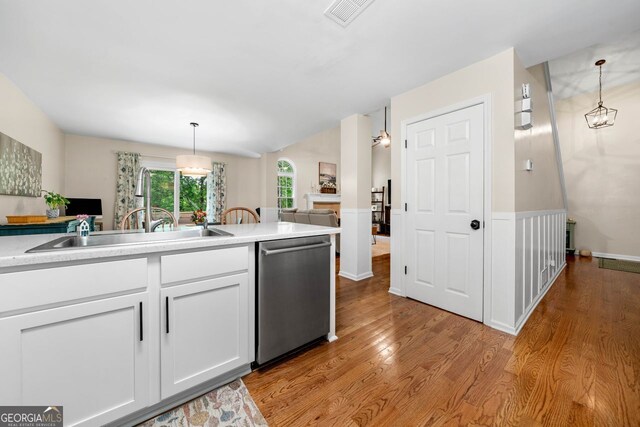 164 Stoneforest Dr, Woodstock, GA 30189 - kitchen featuring dishwasher, light wood finished floors, white cabinets, and hanging light fixtures