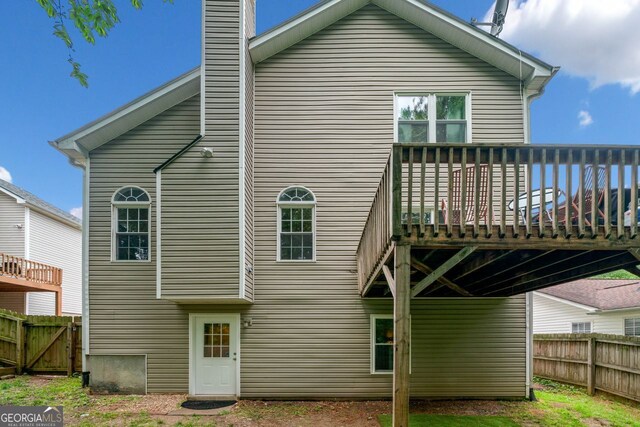 164 Stoneforest Dr, Woodstock, GA 30189 - back of property with a deck and a chimney