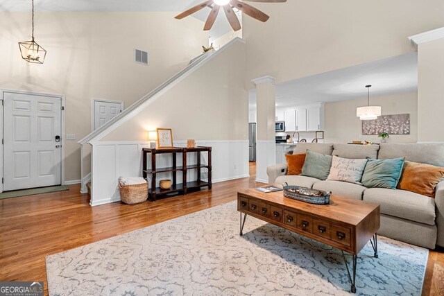 164 Stoneforest Dr, Woodstock, GA 30189 - living room featuring light wood-type flooring, ceiling fan, high vaulted ceiling, and stairway