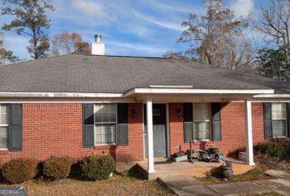 906 Saint Nicholas Ave, Brewton, AL 36426 - single story home with brick siding, a chimney, and a porch
