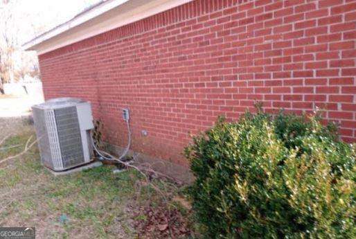 906 Saint Nicholas Ave, Brewton, AL 36426 - view of home's exterior featuring brick siding and cooling unit