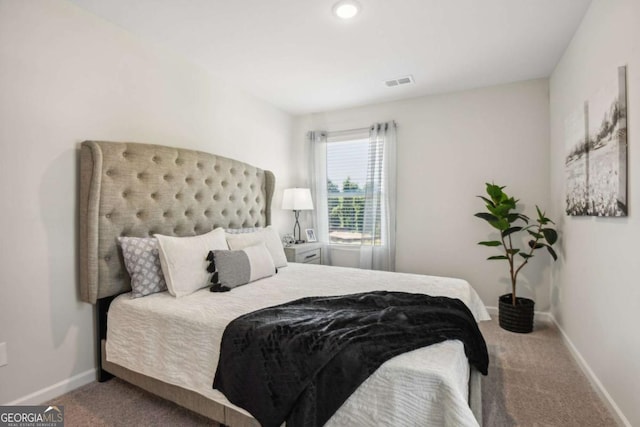 carpeted bedroom featuring baseboards and recessed lighting