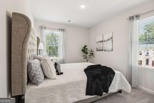 carpeted bedroom featuring baseboards and recessed lighting