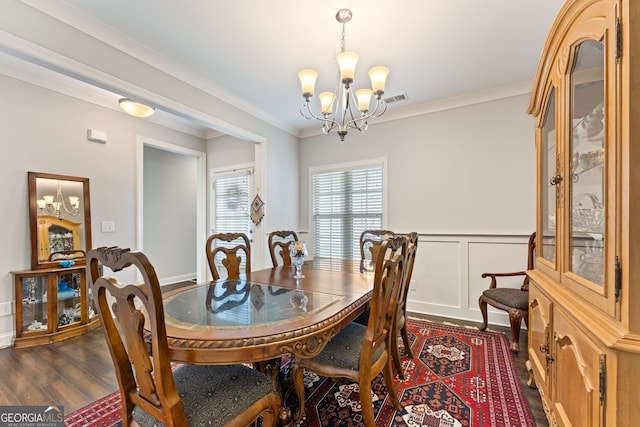 3219 Blackshear Dr, Marietta, GA 30060 - dining area featuring a chandelier, dark wood-type flooring, crown molding, and wainscoting