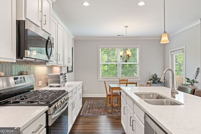 3219 Blackshear Dr, Marietta, GA 30060 - kitchen with appliances with stainless steel finishes, a sink, ornamental molding, dark wood-style flooring, and decorative backsplash