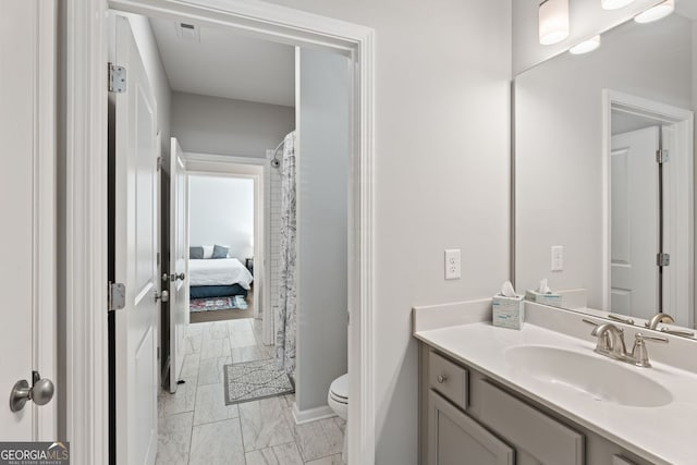 3219 Blackshear Dr, Marietta, GA 30060 - bathroom featuring marble look tile flooring, toilet, and vanity