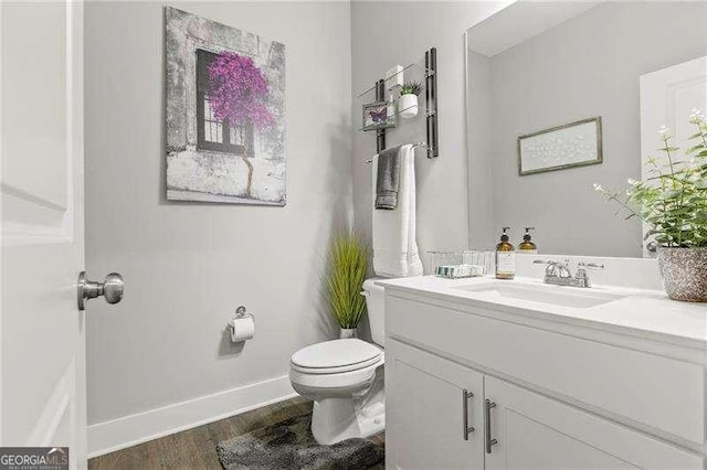 1700 Prospect Way, Conyers, GA 30094 - half bathroom featuring wood finished floors, toilet, baseboards, and vanity