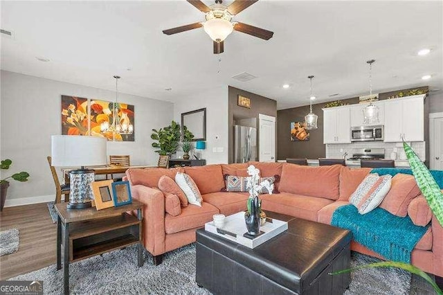 1700 Prospect Way, Conyers, GA 30094 - living room featuring ceiling fan, recessed lighting, baseboards, wood finished floors, and a chandelier