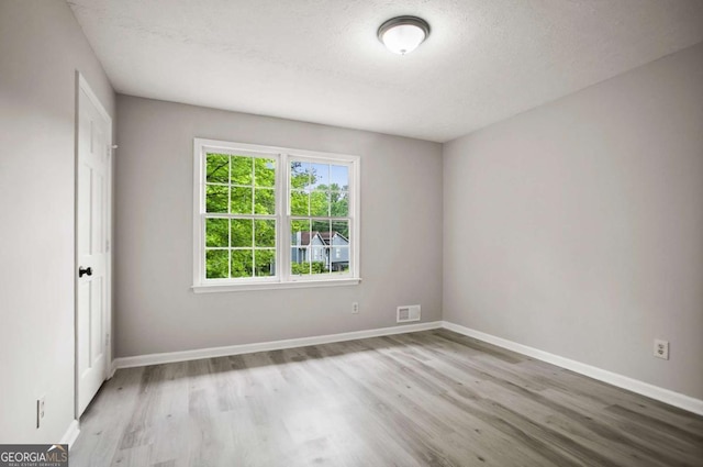 6549 Biscayne Way, Douglasville, GA 30135 - unfurnished room with wood finished floors, baseboards, and a textured ceiling
