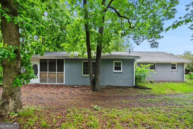 6549 Biscayne Way, Douglasville, GA 30135 - rear view of property featuring a sunroom and brick siding