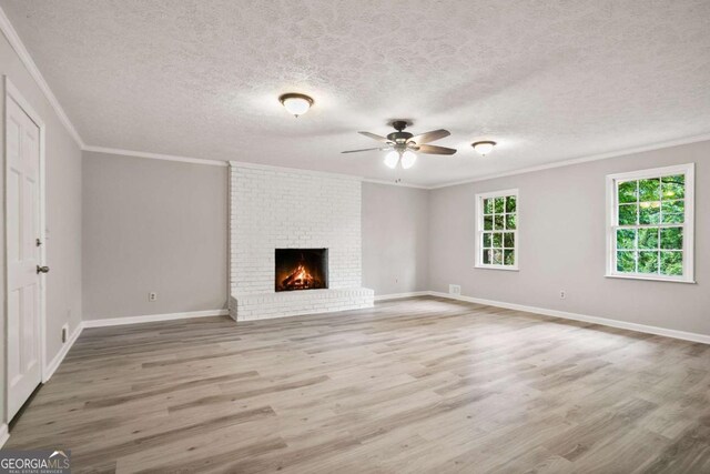 6549 Biscayne Way, Douglasville, GA 30135 - unfurnished living room with ornamental molding, a ceiling fan, wood finished floors, a textured ceiling, and baseboards