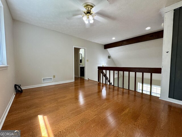 unfurnished room featuring a ceiling fan, wood finished floors, a textured ceiling, baseboards, and recessed lighting