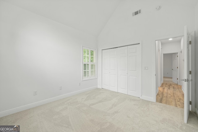 124 Cinder Hill Dr, Brunswick, GA 31523 - unfurnished bedroom featuring carpet floors, high vaulted ceiling, baseboards, and a closet