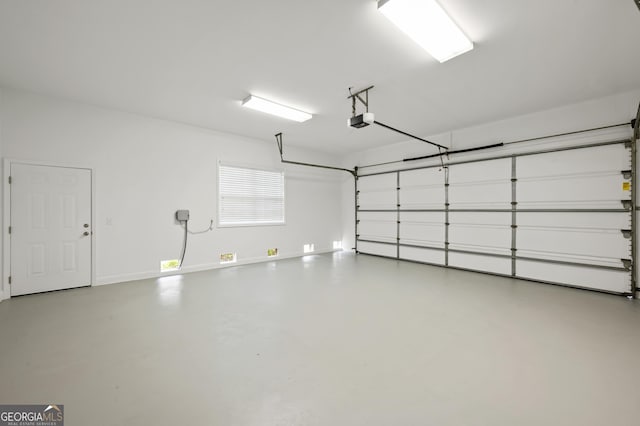124 Cinder Hill Dr, Brunswick, GA 31523 - garage featuring a garage door opener and baseboards