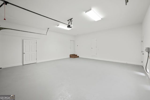 124 Cinder Hill Dr, Brunswick, GA 31523 - garage with a garage door opener and baseboards