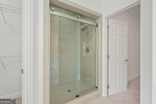 124 Cinder Hill Dr, Brunswick, GA 31523 - full bathroom featuring a shower stall, a spacious closet, and baseboards