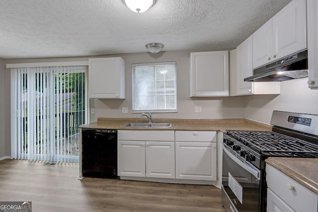 5295 Old Trail Cir, Stone Mountain, GA 30088 - kitchen featuring stainless steel range with gas cooktop, dishwasher, under cabinet range hood, a textured ceiling, and light wood-style floors