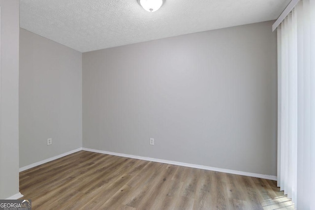 5295 Old Trail Cir, Stone Mountain, GA 30088 - unfurnished room featuring wood finished floors and a textured ceiling