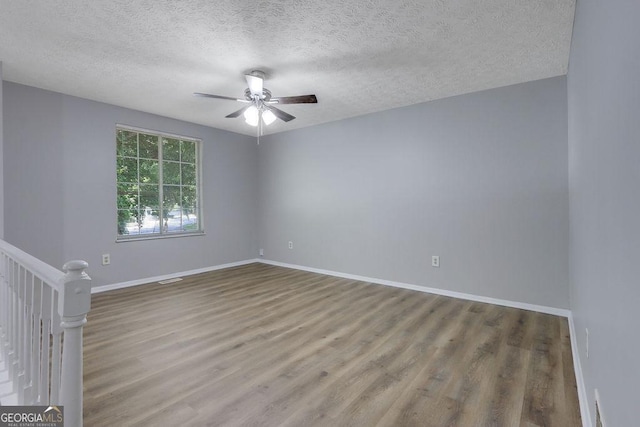 5295 Old Trail Cir, Stone Mountain, GA 30088 - spare room featuring ceiling fan, wood finished floors, and a textured ceiling