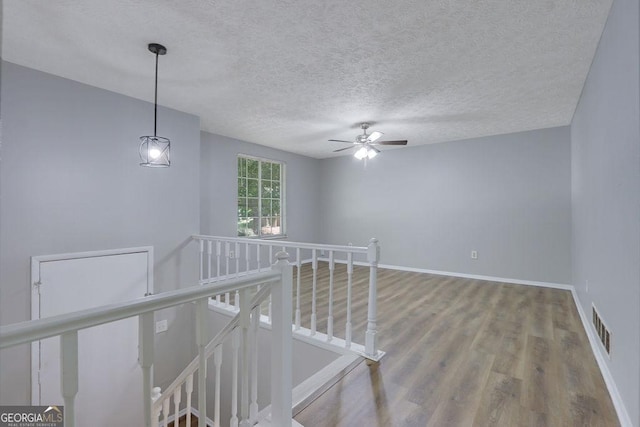5295 Old Trail Cir, Stone Mountain, GA 30088 - empty room with wood finished floors, a textured ceiling, and a ceiling fan
