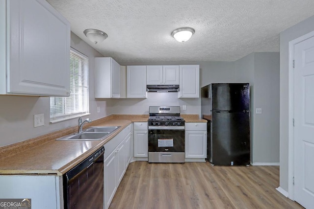 5295 Old Trail Cir, Stone Mountain, GA 30088 - kitchen with black appliances, under cabinet range hood, white cabinetry, light wood-style floors, and a textured ceiling