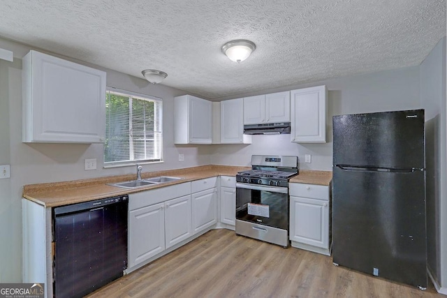 5295 Old Trail Cir, Stone Mountain, GA 30088 - kitchen featuring black appliances, under cabinet range hood, white cabinetry, light wood finished floors, and a textured ceiling