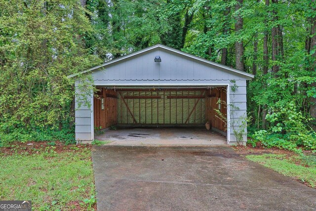 detached garage featuring a wooded view
