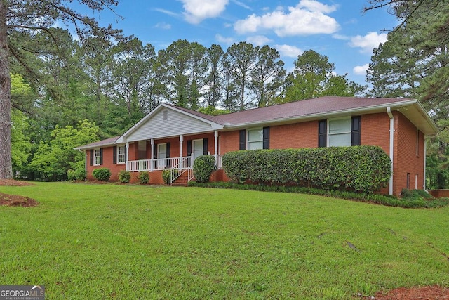 single story home featuring covered porch, brick siding, and a front lawn
