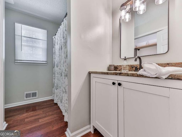 3500 Refuge Rd, Jasper, GA 30143 - full bath featuring wood finished floors, baseboards, vanity, a textured ceiling, and a shower with curtain