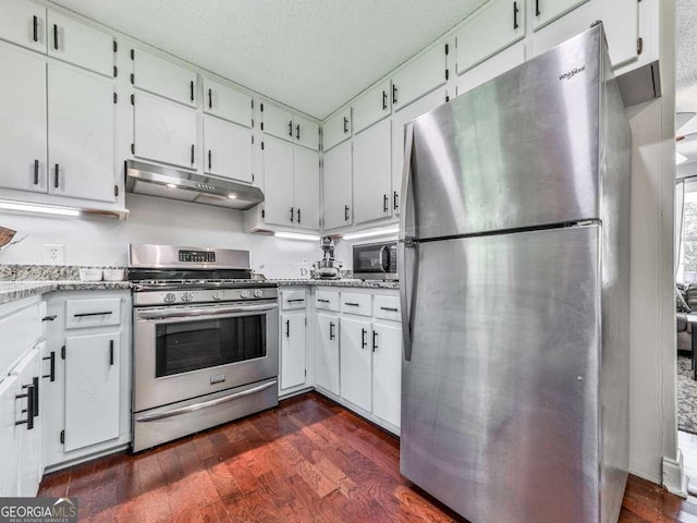 3500 Refuge Rd, Jasper, GA 30143 - kitchen featuring under cabinet range hood, appliances with stainless steel finishes, dark wood-type flooring, white cabinets, and a textured ceiling