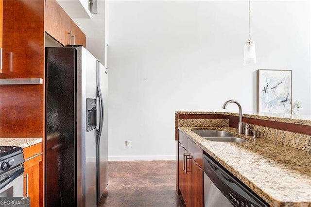 964 Dekalb Ave NE Unit 112, Atlanta, GA 30307 - kitchen featuring stainless steel appliances, a sink, brown cabinets, light stone countertops, and concrete floors