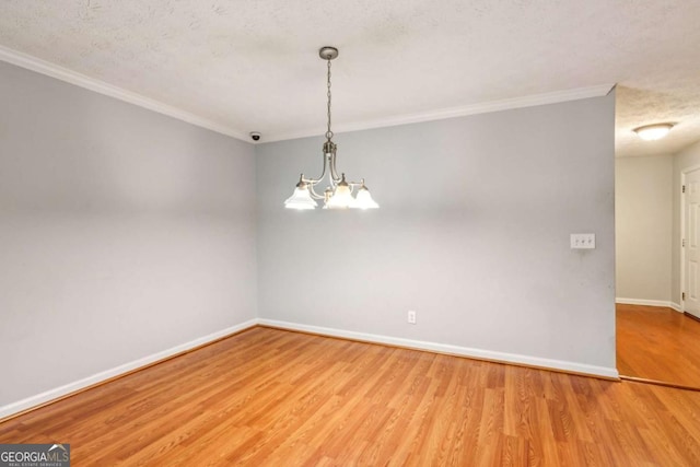 721 Beaufort Cir, Duluth, GA 30096 - empty room featuring ornamental molding, wood finished floors, a chandelier, and a textured ceiling