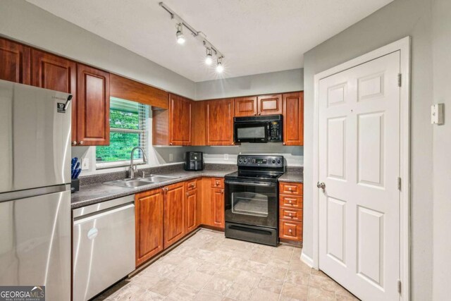 721 Beaufort Cir, Duluth, GA 30096 - kitchen featuring black appliances, a sink, dark countertops, and brown cabinetry