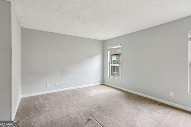 721 Beaufort Cir, Duluth, GA 30096 - empty room with carpet floors, a textured ceiling, and baseboards