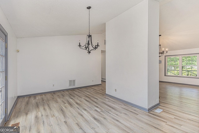 5406 Jamestowne Dr, Powder Springs, GA 30127 - unfurnished dining area featuring a chandelier, wood finished floors, vaulted ceiling, and baseboards
