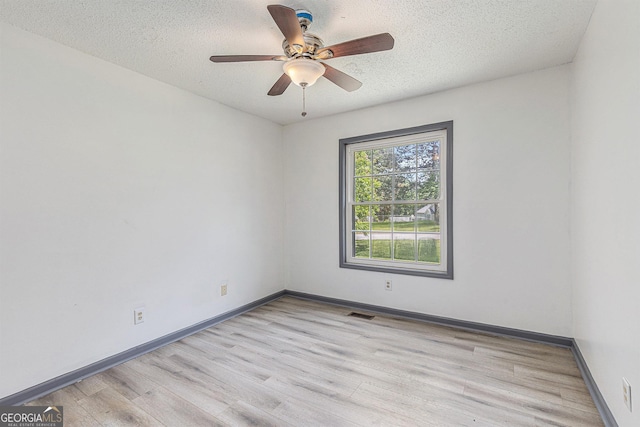 5406 Jamestowne Dr, Powder Springs, GA 30127 - unfurnished room with light wood-style floors, a textured ceiling, baseboards, and ceiling fan