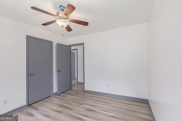 5406 Jamestowne Dr, Powder Springs, GA 30127 - unfurnished room featuring light wood finished floors, baseboards, a textured ceiling, and a ceiling fan