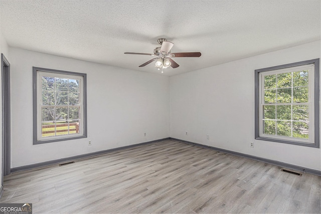 5406 Jamestowne Dr, Powder Springs, GA 30127 - spare room with light wood-type flooring, a ceiling fan, baseboards, and a textured ceiling