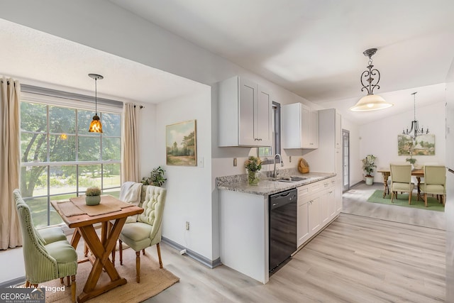 5406 Jamestowne Dr, Powder Springs, GA 30127 - kitchen with black dishwasher, a sink, light wood-style flooring, light stone counters, and white cabinets