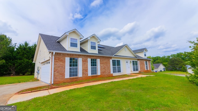 new england style home featuring brick siding, a front lawn, concrete driveway, and a shingled roof