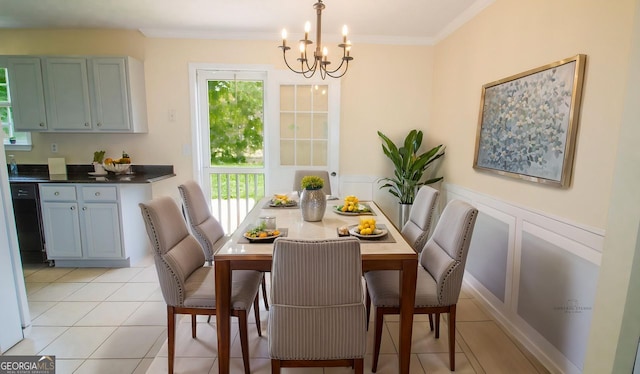 dining space with a chandelier, crown molding, and light tile patterned flooring
