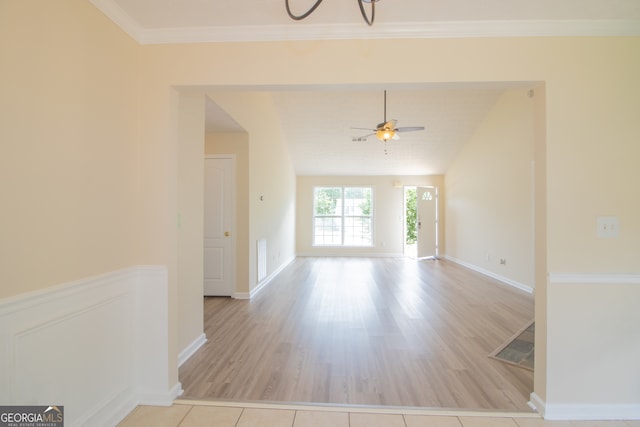 empty room with ceiling fan, wood finished floors, and baseboards