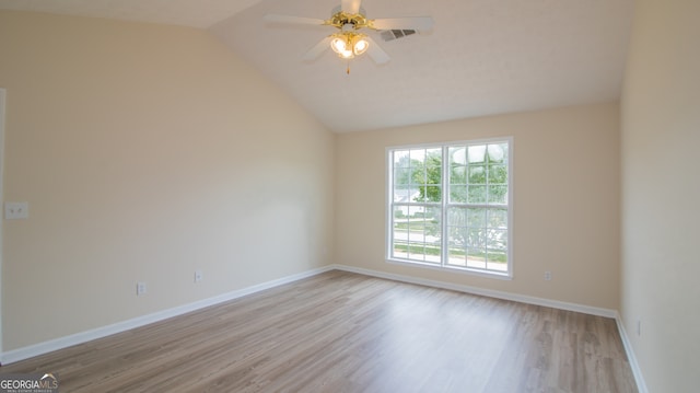 unfurnished room featuring wood finished floors, baseboards, lofted ceiling, and a ceiling fan
