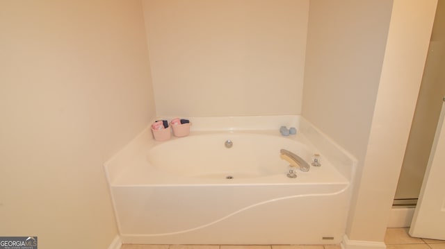 full bathroom with tile patterned flooring, a bath, and baseboards