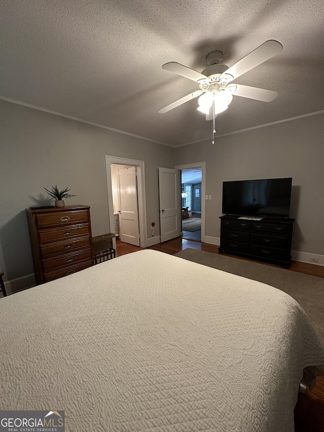 bedroom featuring a textured ceiling, baseboards, and ceiling fan
