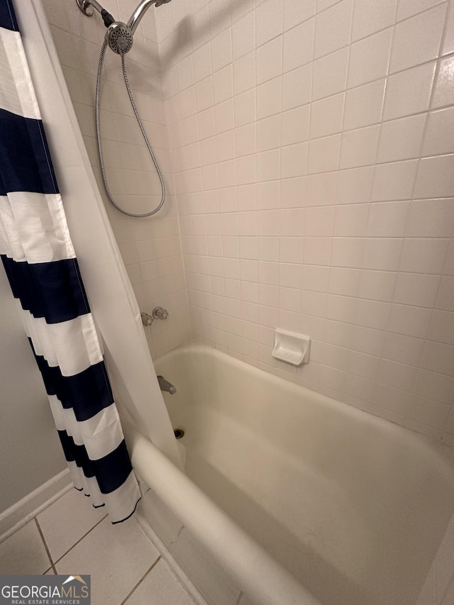 full bath featuring tile patterned floors, shower / bathtub combination with curtain, and baseboards
