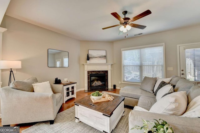 2505 Thackery Ct, Cumming, GA 30041 - living room featuring a ceiling fan, a fireplace, light wood finished floors, and baseboards