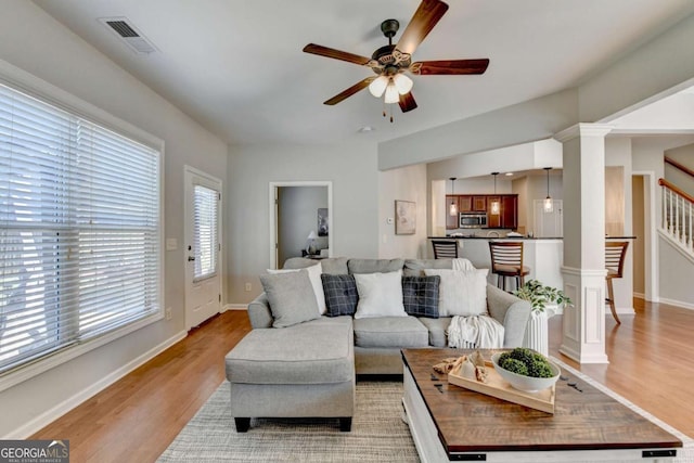 2505 Thackery Ct, Cumming, GA 30041 - living room with ceiling fan, light wood-style flooring, stairway, and baseboards